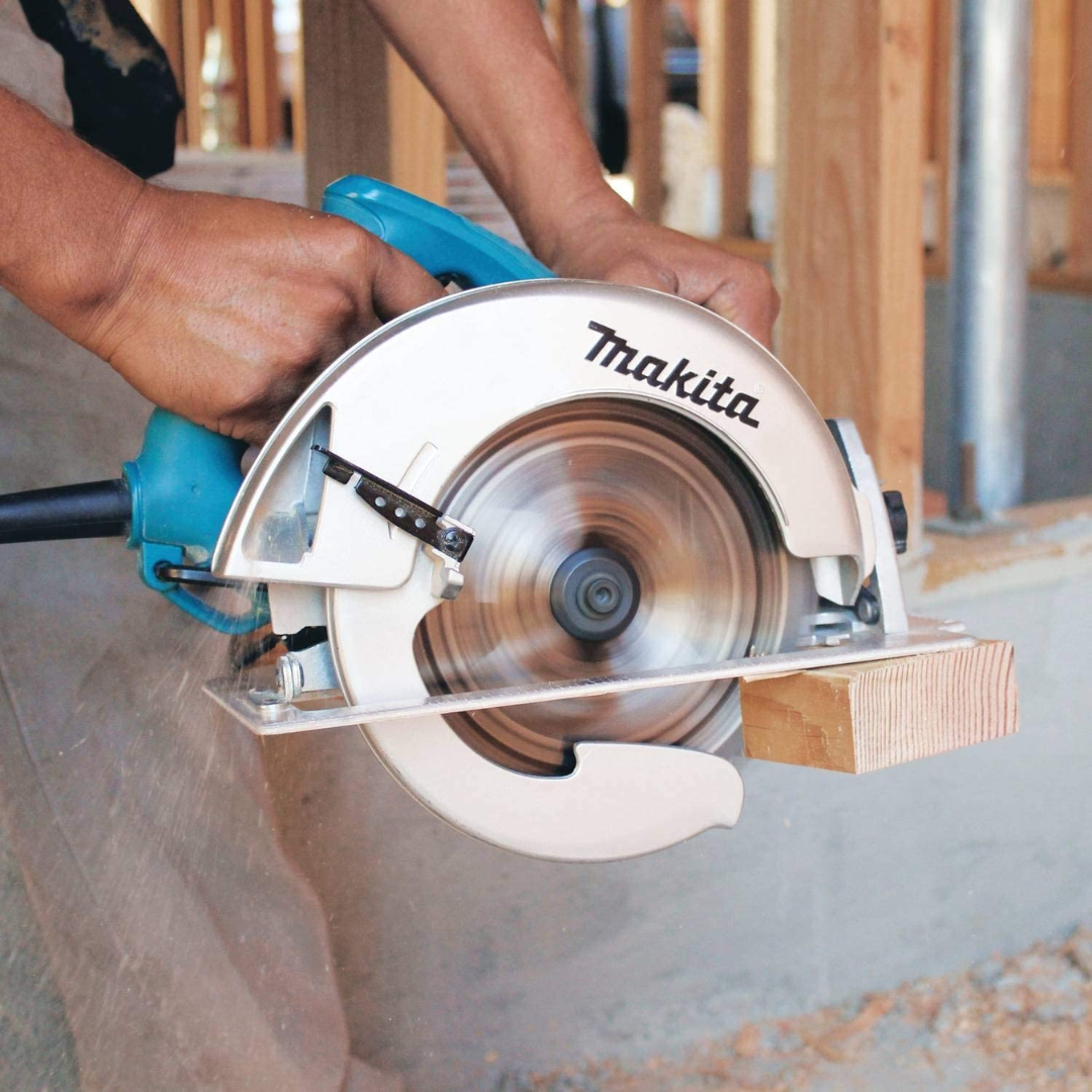 Person using a Makita circular saw to cut wood.